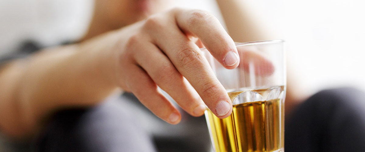 Image of a man holding a glass of beer.